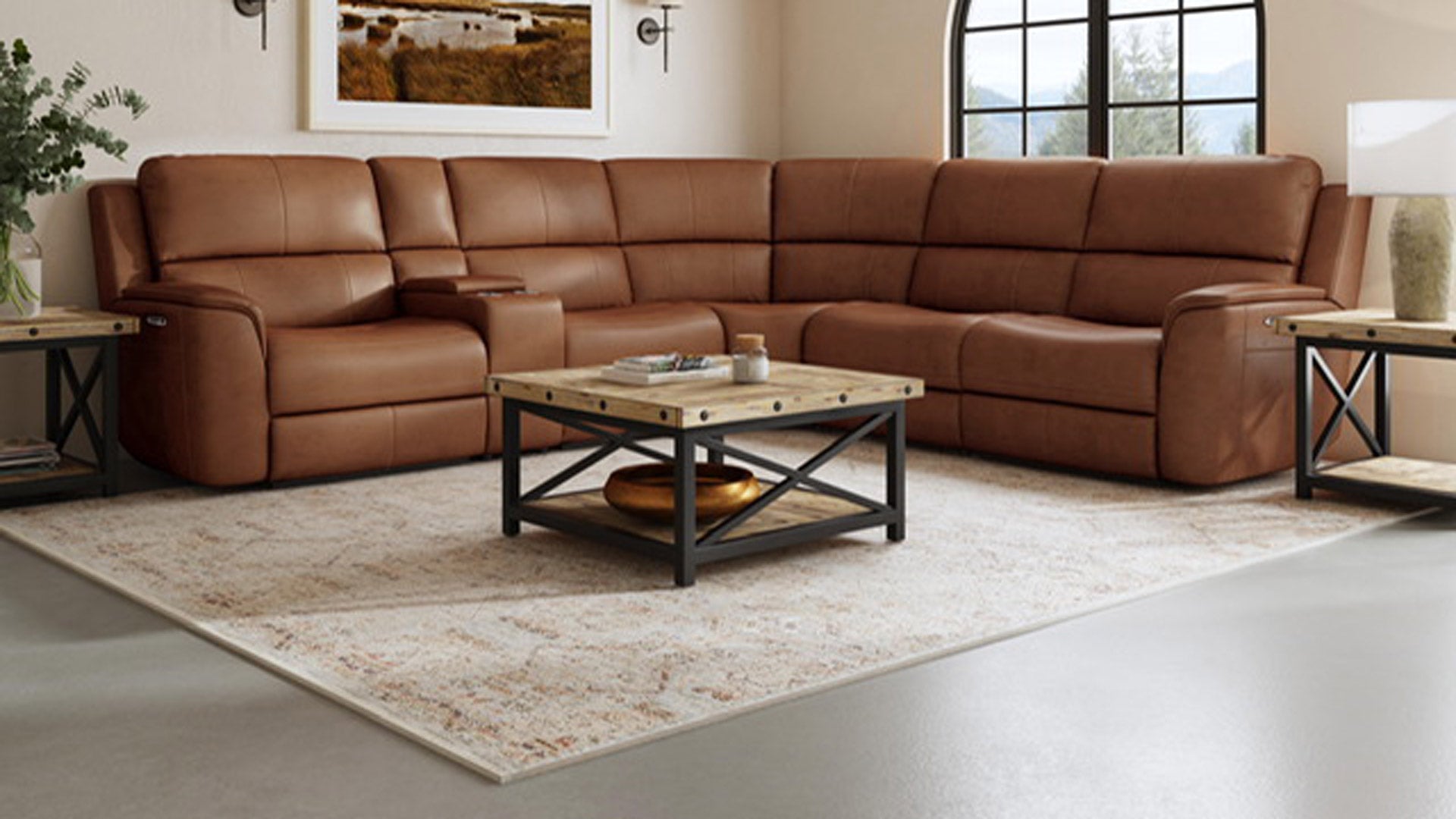 A large brown leather sectional sofa with power reclining features, situated in a room with a modern coffee table and rug.