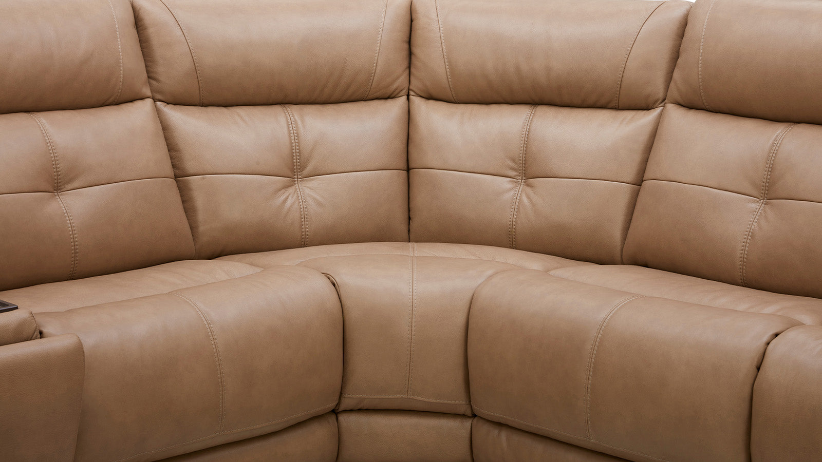 Close-up of a beige leather sectional sofa