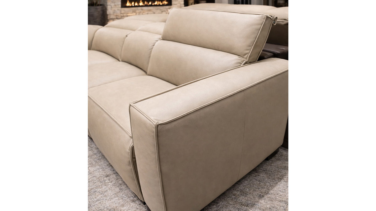 Beige sectional sofa in a room with a fireplace.