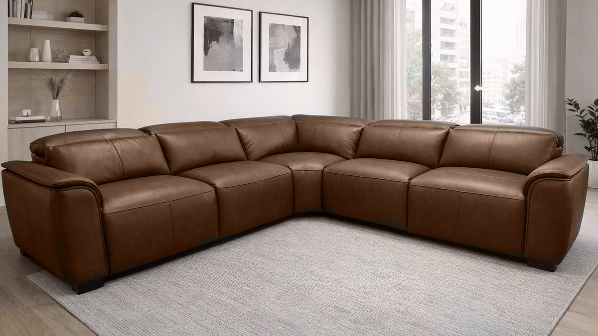 Brown leather sectional sofa in a living room setting with decor elements.