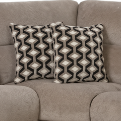 Two patterned pillows on a gray sofa