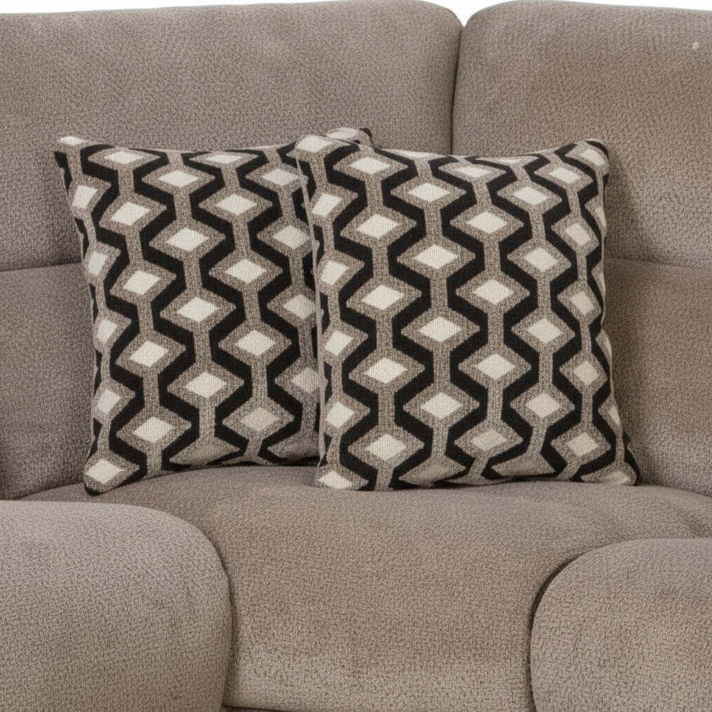 Two patterned pillows on a gray sofa