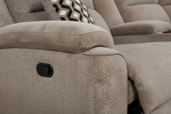 Close-up of a beige recliner chair with a control knob.