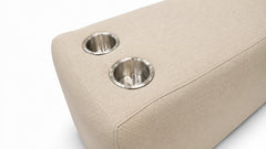 Close-up of a beige woven upholstered furniture piece with two circular stainless steel cup holders on a white background.