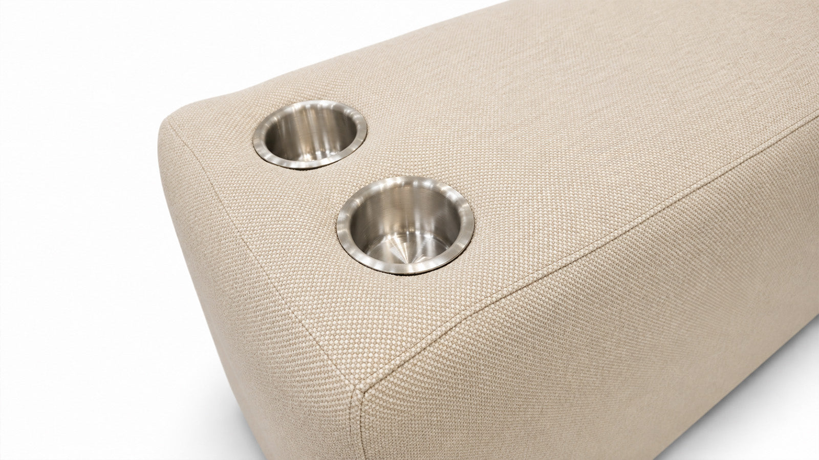 Close-up of a beige woven upholstered furniture piece with two circular stainless steel cup holders on a white background.