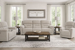 Living room with beige sofa, armchairs, and a wooden coffee table.