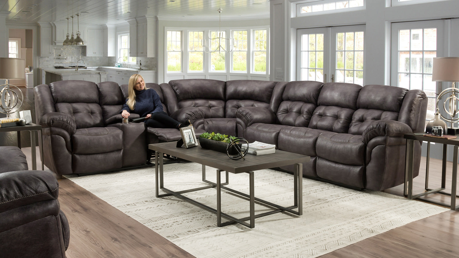 room scene with with lady sitting on the Marcelina Charcoal sectional