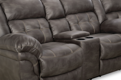 Gray microfiber reclining sofa with cup holders on a white background