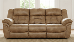 Brown leather sofa in a room with large windows.