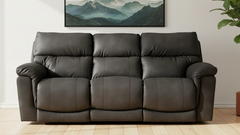 Gray leather sofa in a room with a mountain painting on the wall.