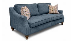 A three-seater loveseat sofa upholstered in textured blue fabric, featuring two patterned throw pillows and turned wooden legs, shown on a white background.