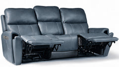 A three-seat reclining sofa in dark blue-gray leather, shown with both outer armrests extended into footrests against a plain white studio background.