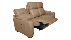 A tan leather reclining loveseat sofa with one seat cushion extended into a reclining position, featuring a side cup holder and dark metal support mechanism, shown against a plain white background.