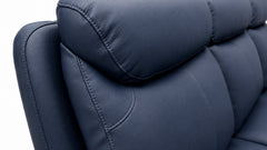 Close-up of a blue leather sofa with a white background