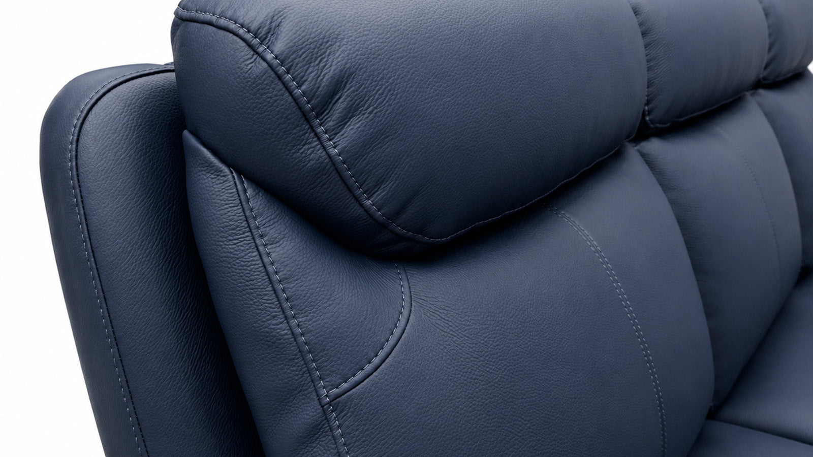 Close-up of a blue leather sofa with a white background