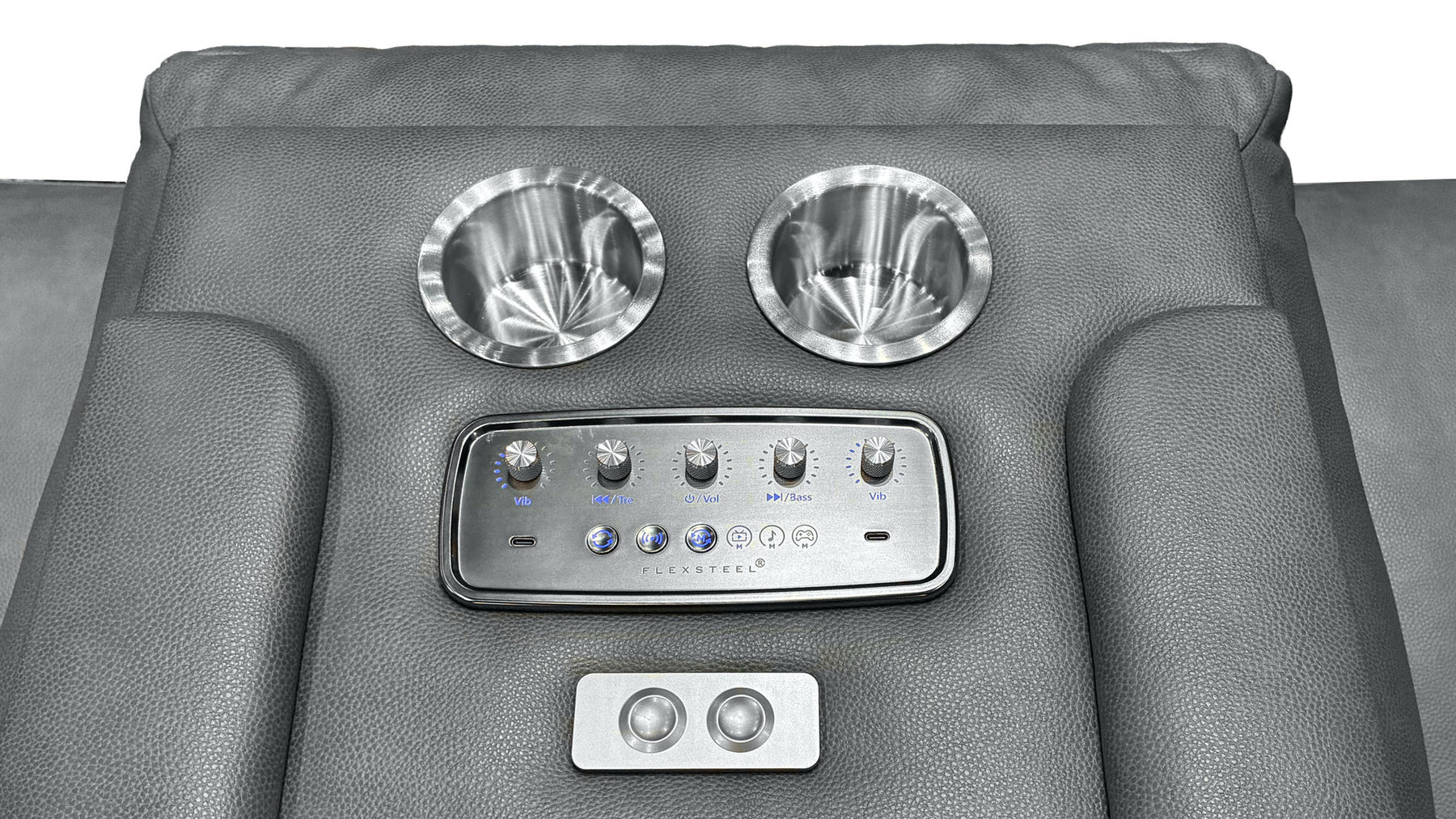 Close-up of a gray leather recliner backrest with two metallic cup holders, a central control panel, and a smaller lower control panel.