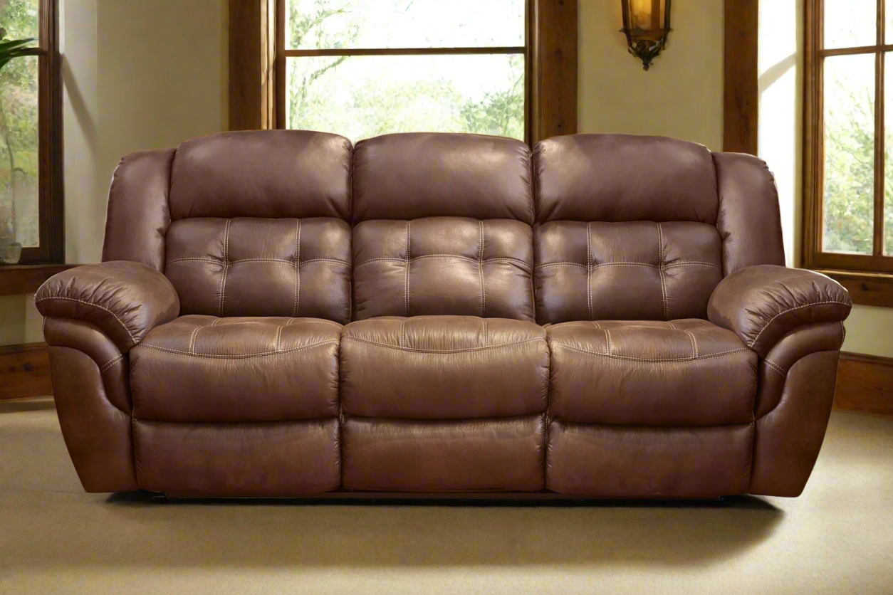 Brown leather sofa in a room with large windows.