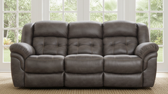 Gray leather sofa in a room with large windows