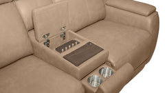 Close-up of a beige leather reclining sofa center console with a folded-down armrest, showing a dark wood tray table, metal hinges, and two stainless steel cup holders.