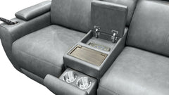 Gray leather reclining sofa with an open center console armrest showing a wood-look tray table, cup holders, and a control panel, photographed on a white background.