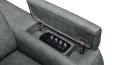 Close-up of a gray upholstered seat with the backrest folded down to reveal an integrated control panel with knobs and a digital display.