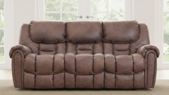 Brown leather sofa in a room with large windows