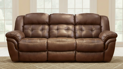 Brown leather sofa in a room with large windows.