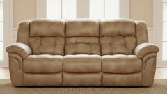 Brown leather sofa in a room with large windows.