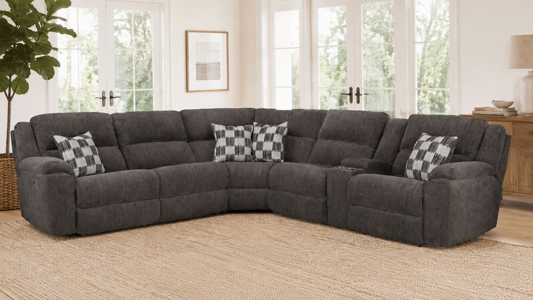 Gray sectional sofa with checkered pillows in a living room setting.