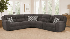 Gray sectional sofa with checkered pillows in a living room setting.