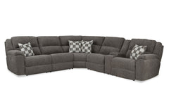 Gray sectional sofa with checkered pillows on a white background