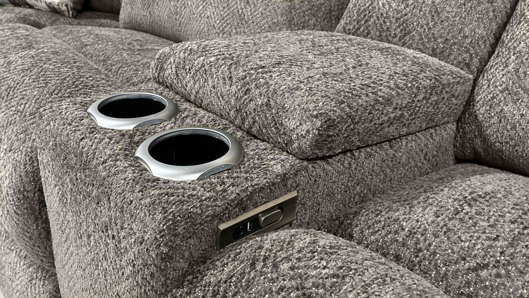 Gray textured sofa with cup holders and power outlet