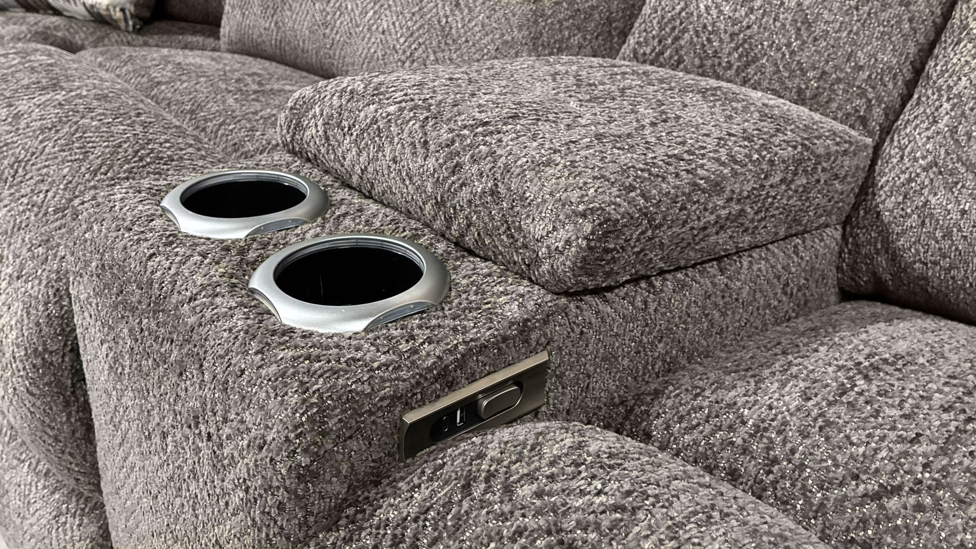 Gray textured sofa with cup holders and power outlet