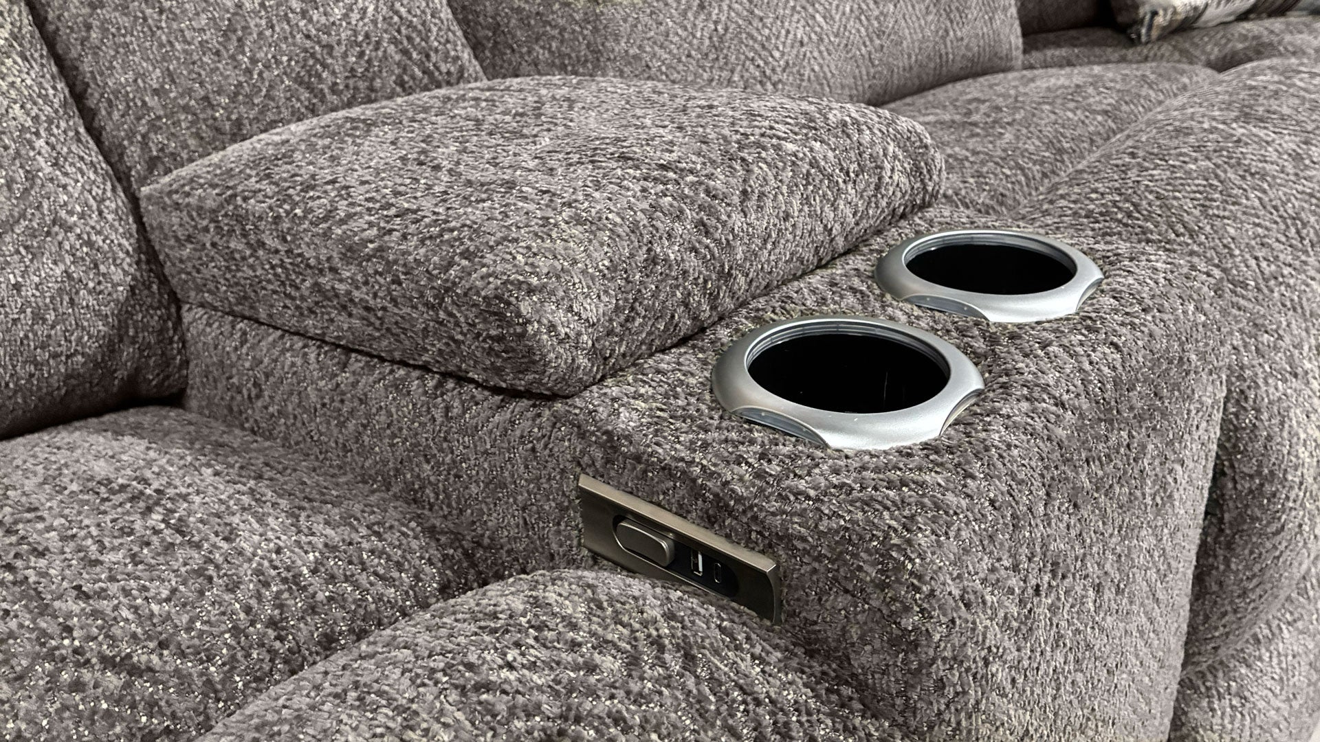 Gray recliner sofa with cup holders and power outlet