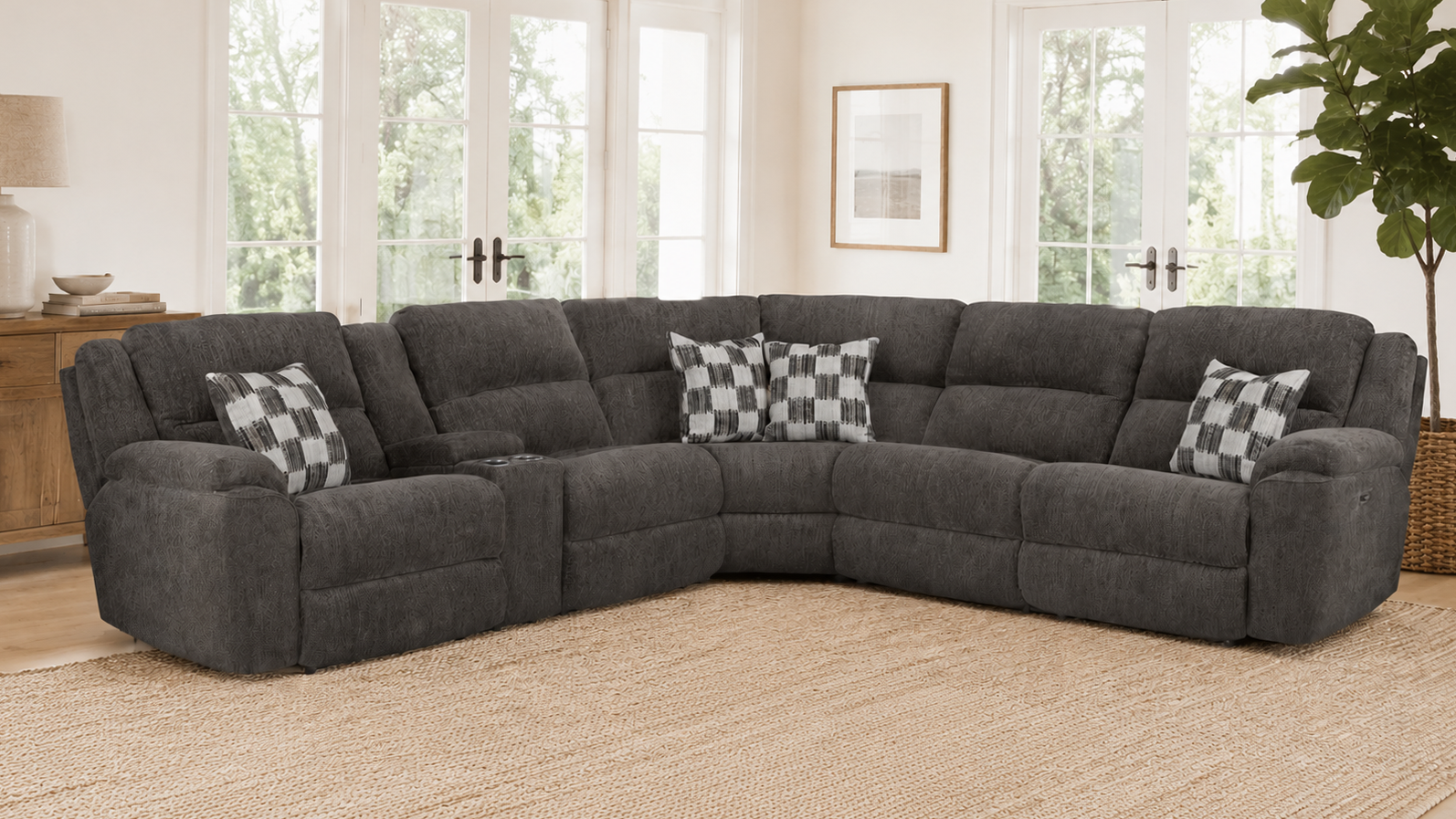 Gray sectional sofa with checkered pillows in a living room setting.