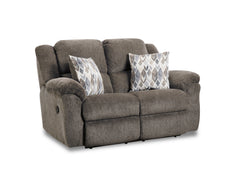 Gray sofa with patterned cushions on a white background