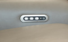 Control panel with multiple buttons on a vehicle's interior ceiling.
