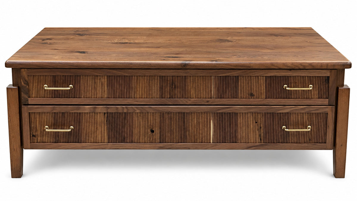 A mid-century modern wooden coffee table with two drawers featuring vertical reed or rattan inserts and brass handles, shown against a plain white background.