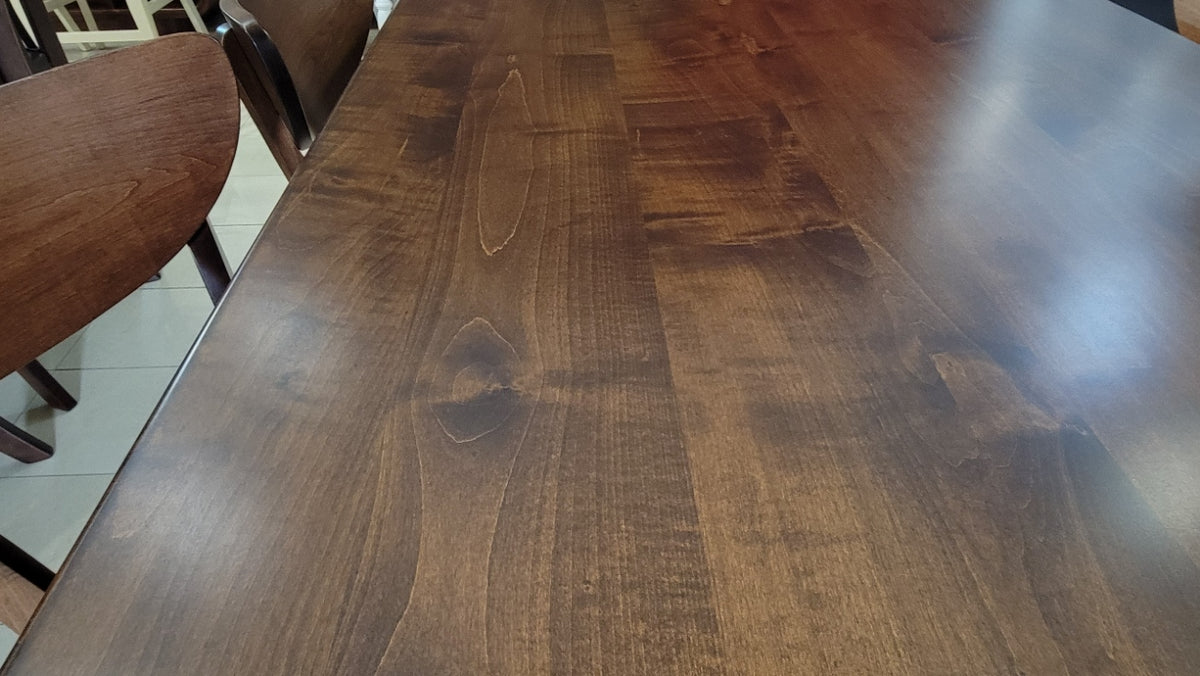 Wooden dining table with chairs in a room setting
