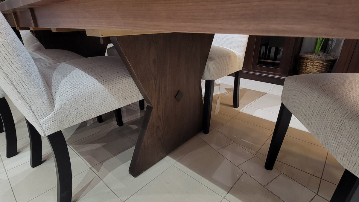 Dining table with chairs in a room with a tiled floor and furniture.