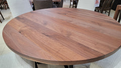 Round wooden table in a room with chairs