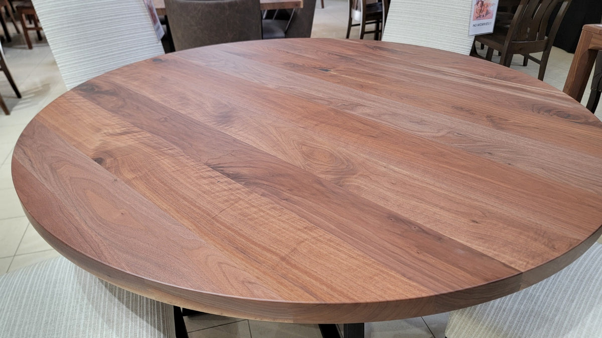 Round wooden table in a room with chairs