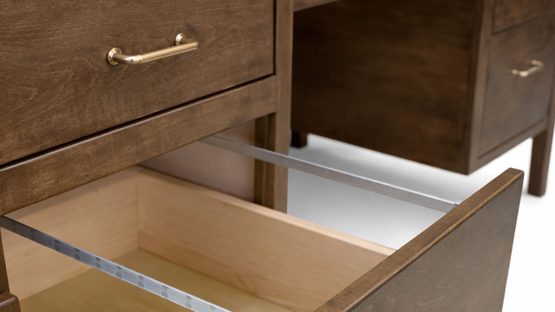 Wooden drawer with gold handle on a white background