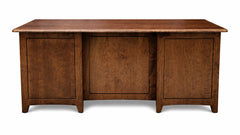 Wooden desk with three drawers on a white background