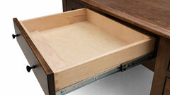 Wooden drawer being pulled out from a desk