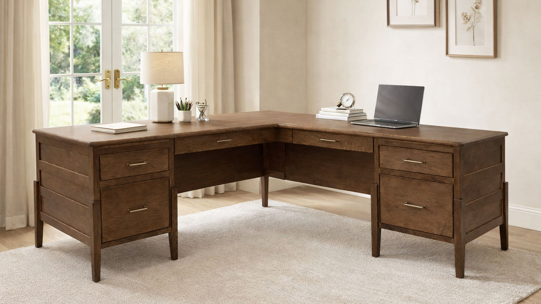 Wooden L-shaped desk in a home office setting with a laptop and decor items.