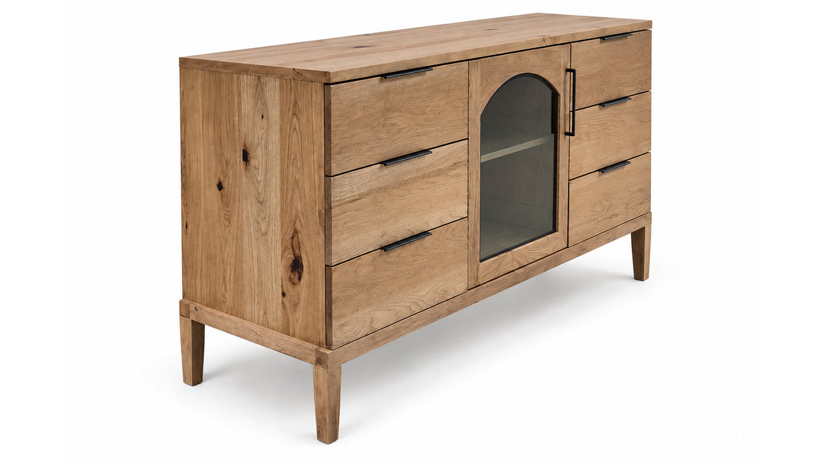 A mid-century modern wooden sideboard cabinet with a natural oak finish, featuring five drawers on the left, a glass-front door with an arched top on the right, and dark metal handles, shown on a white background.
