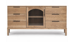 A light oak wood sideboard cabinet with six drawers, a central arched door, and two open shelves, shown on a white background.