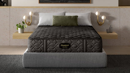 Gray mattress on a bed in a modern bedroom with abstract art and shelves.