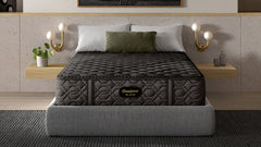 Gray mattress on a bed in a modern bedroom with abstract art and shelves.